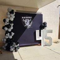 Black and silver balloon arch with a "Raiders" logo and the number "45" displayed.