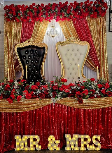 Weddings Elegant wedding backdrop with black and white chairs, red roses, and golden accents.